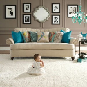 Cute baby sitting on carpet floor | CarpetsPlus COLORTILE