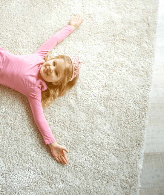 Cute girl laying on rug | CarpetsPlus COLORTILE
